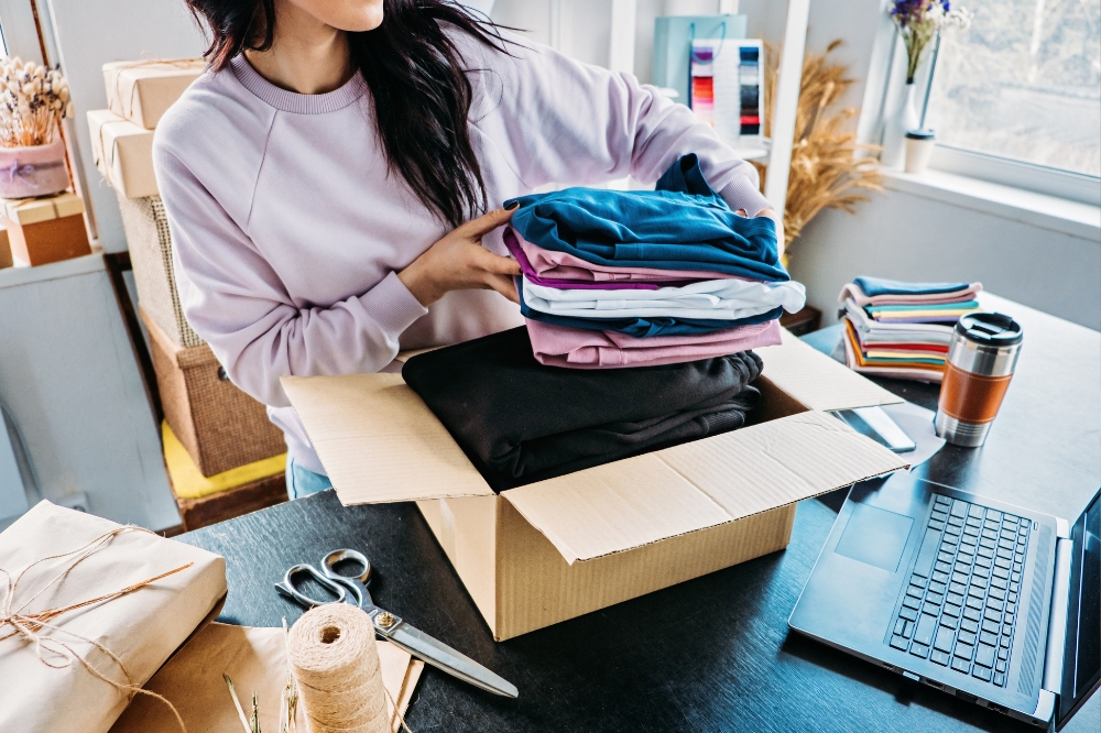 woman packing an order for clothing