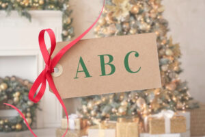 Christmas tree by fireplace and gift tag with ABC written on it