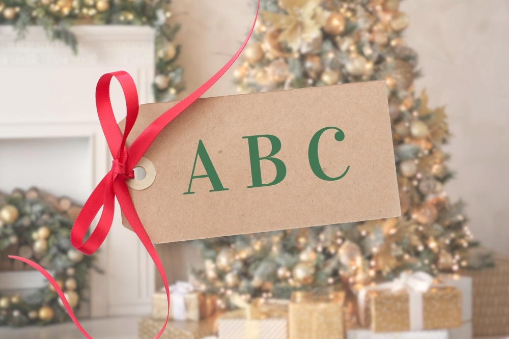 Christmas tree by fireplace and gift tag with ABC written on it
