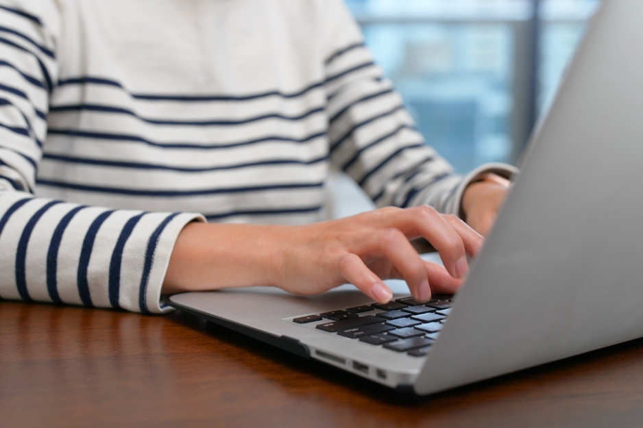 woman typing on a laptop