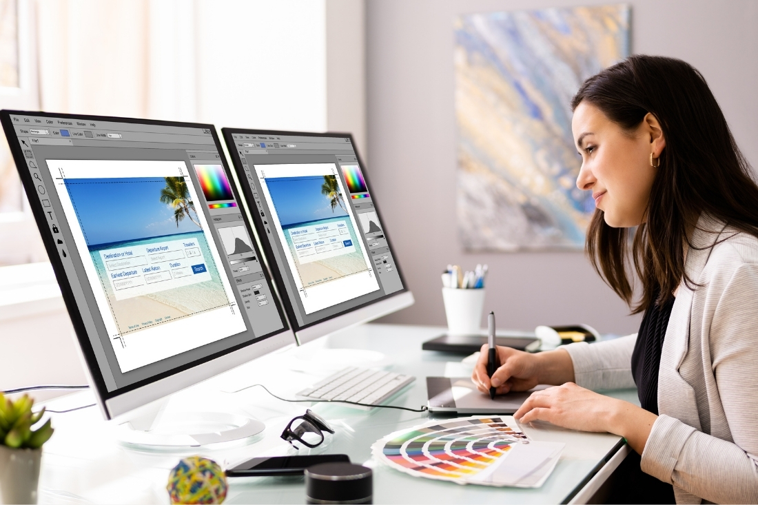 female designer working on a design project on two computer screens