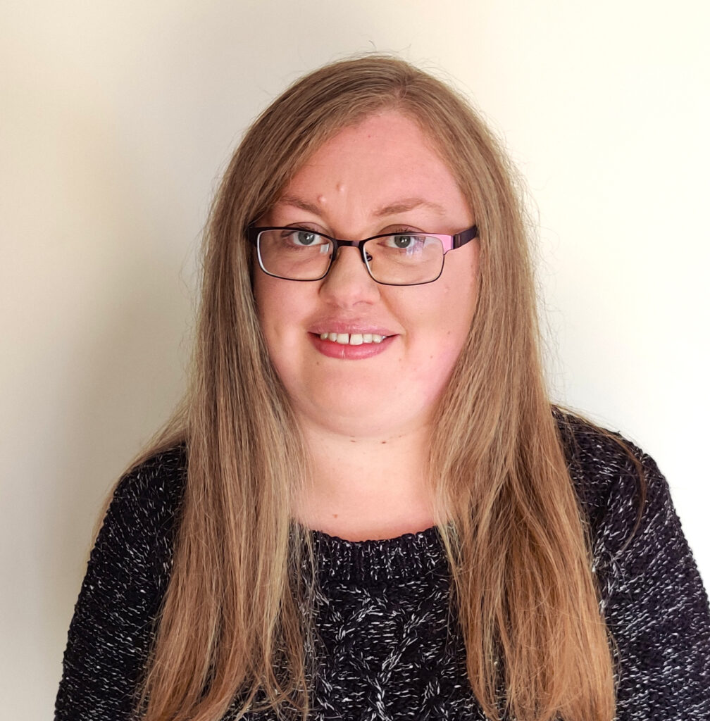 photo of Helen Garfield in dark jumper top and long hair