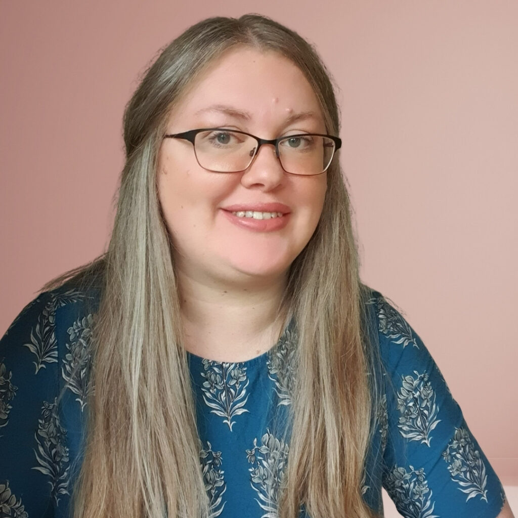 photo of Helen Garfield in teal top and long hair